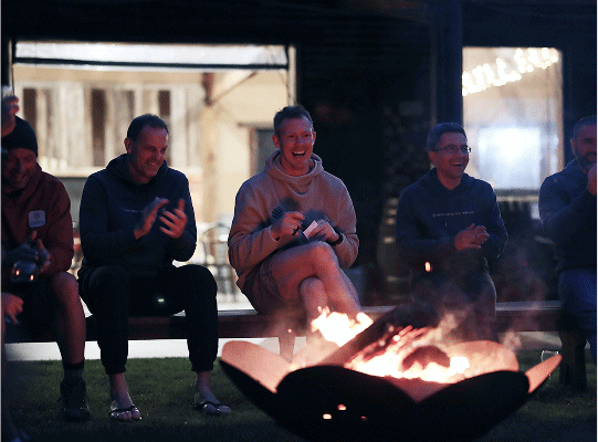 Jack and a team sitting around a camp fire