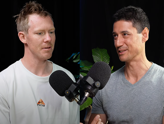 Jack Riewodlt and Daniel Sinh speaking into microphones for Daniels Podacast