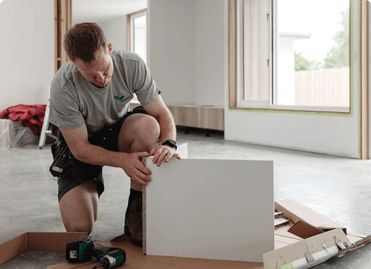Jack Riewoldt drilling together a cabinet in a social media video for Kaboodle Kitchens.