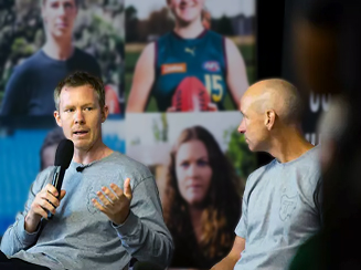 Jack Riewoldt speaking on stage on a panel. He wears a grey jumper.
